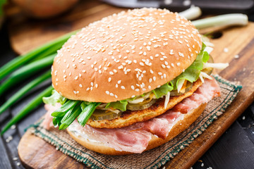 Burger with potato pancake and bacon