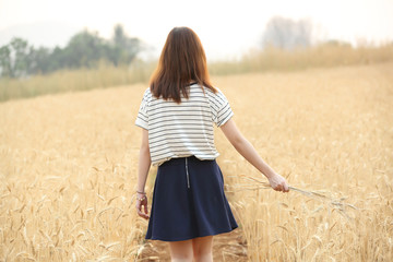 Young woman in wheat