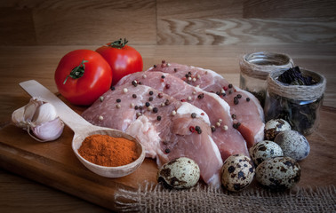 Raw meat cut into steaks or cubes on board with vegetables