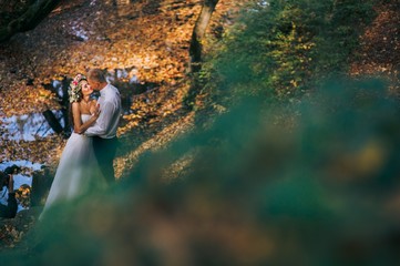young couple on a walk in the autumn forest