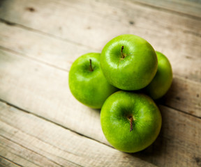fruit. green apples on wooden background