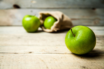 fruit. Ripe green apples with burlap, on wooden  background