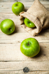 fruit. Ripe green apples with burlap, on wooden  background