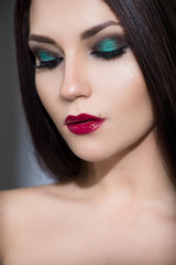 Beautiful young model with red lips and perfect makeup