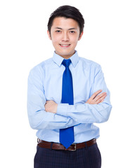 Young satisfied businessman with his arms crossed