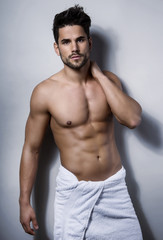 Fototapeta premium handsome young bodybuilder showing of his fit body and muscles