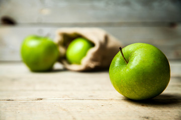 fruit. Ripe green apples with burlap, on wooden  background