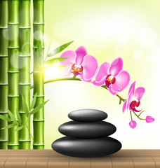 Stack of spa stones with orchid pink flowers and bamboo and sunl