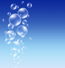 Transparent soap bubbles on blue background