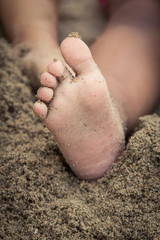 little girl's feet in sand