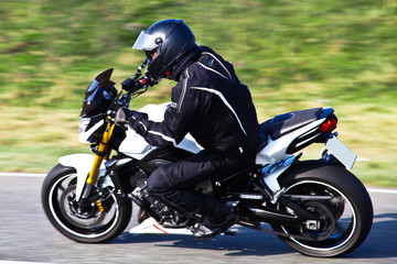 Obraz na płótnie Canvas Motorcyclist biker on the road