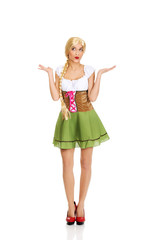 Fototapeta premium Woman wearing Bavarian dress with open hands.