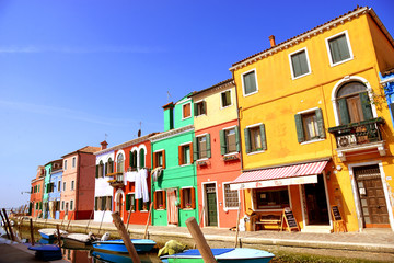 Fototapeta na wymiar Burano island canal, colorful houses and boats, Italy