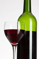 Wine glass and bottle with red wine