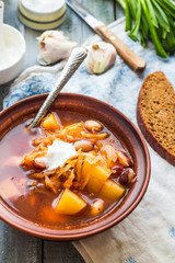red soup with beans, beets, cabbage and potatoes, sour cream