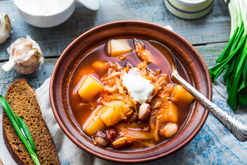 red borsch with beans, sour cream, wild garlic, rye bread, rusti