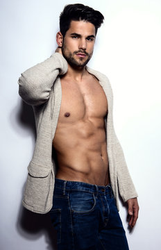 handsome young bodybuilder showing of his fit body and muscles