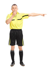 Angry football referee blowing a whistle