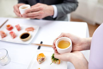 close up of couple drinking tea at restaurant