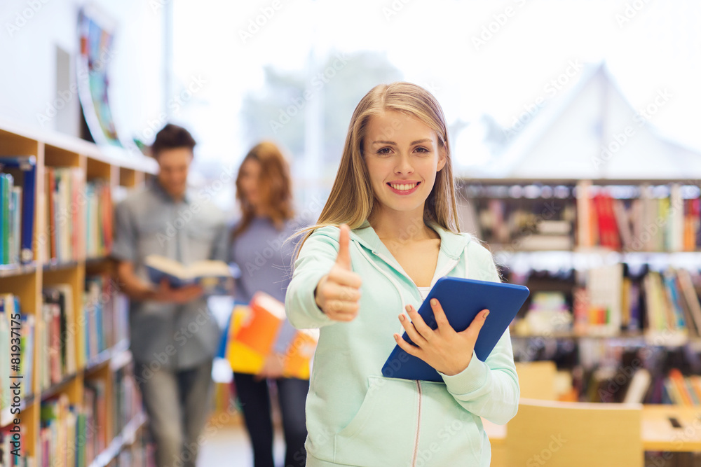 Wall mural happy student girl with tablet pc in library