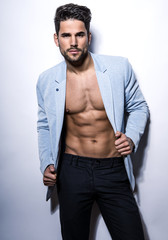 handsome young bodybuilder showing of his fit body and muscles