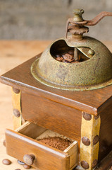 Vintage coffee grinder on rustic background.