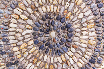 pebbles arranged circle on the wall