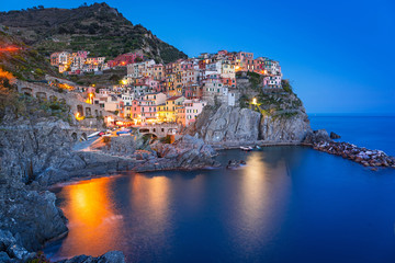Fototapeta na wymiar Manarola town on the coast of Ligurian Sea at dusk, Italy