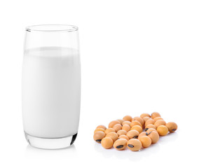 fresh milk in the glass with soy beans on white background