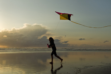 Flying a kite at sunset in Newport, Oregon.