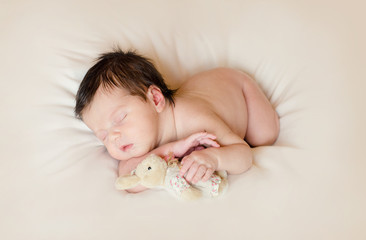 baby sleeps with a toy