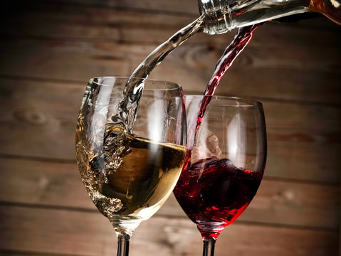 Red and white wine pour in two glasses