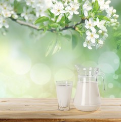 Milk. Milk on table and sunny trees
