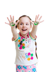 Little girl showing painted hands with funny face