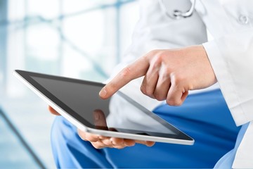 User. Close-shot of male hands holding a tablet in hands