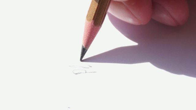 Hand with pencil wrights down