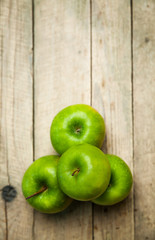 fruit. green apples on wooden background