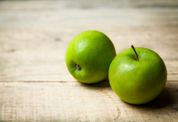 fruit. green apples on wooden background