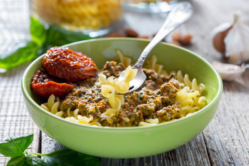 Pasta with pesto with dried tomatoes, garlic and chili.