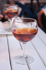 Glass of wine on the white table.Sweet dessert Italian red wine.