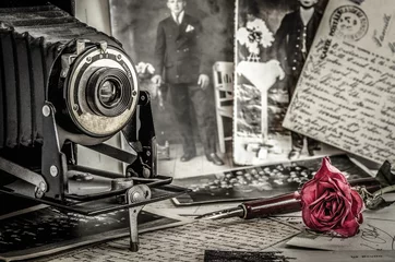 Deurstickers Still life of Antique bellows camera, handwritten letter and rose blossom on table © patila