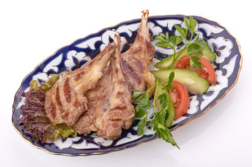 Meat on a grill with vegetables