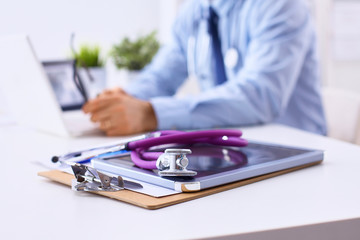 Fototapeta premium Male doctor sitting at his desk