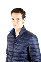 Studio shot of a young man with blue anorak