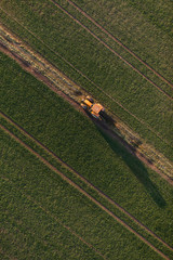 Obraz premium aerial view of harvest fields with tractor