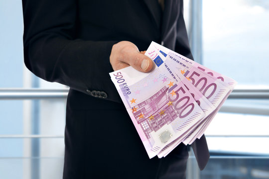 A businessman holding money - Euro (EUR)