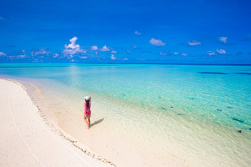 Fototapeta na wymiar Young beautiful woman relaxing at white sand tropical beach