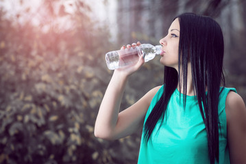 Girl drinking water in park