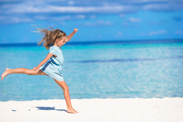 Adorable little girl during beach vacation having fun