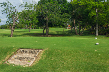 Fototapeta premium Golf course in Dominican republic. field of grass and coconut